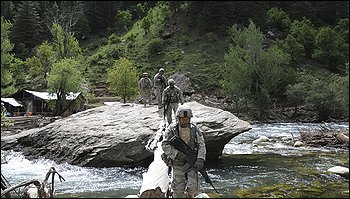 U.S. soldiers pass a makeshift bridge on a patrol in Parun, the capital of Nurestan province, east of Kabul, the day before the deadly attack.
