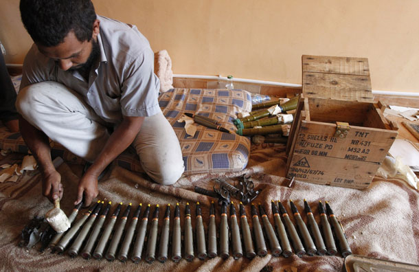 An anti-Gaddafi fighter prepares ammunition in the center of Sirte (Pic: Reuters)
