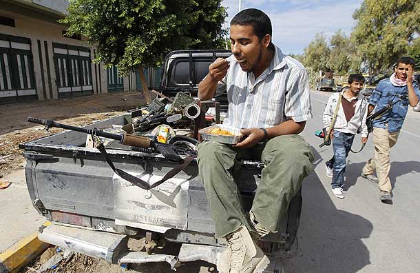 An anti-Gaddafi fighter takes a break during clashes with pro-Gaddafi forces in Sirte (Pic: Reuters)