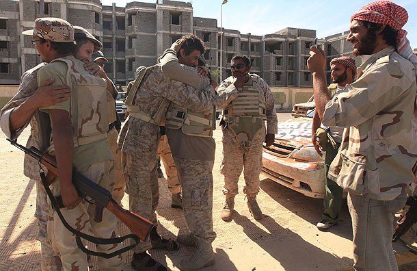Anti-Gaddafi fighters hug as they celebrate the fall of Sirte (Pic: Reuters)