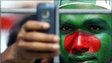 A Bangladeshi fan shoots photographs with his mobile phone during a Cricket World Cup match against Ireland, in Dhaka, Bangladesh, 25 Feb 2011