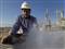Image: A Libyan oil worker, works at a refinery inside the Brega oil complex