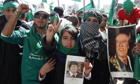Libyans holding pictures of Muammar Gaddafi in Tripoli
